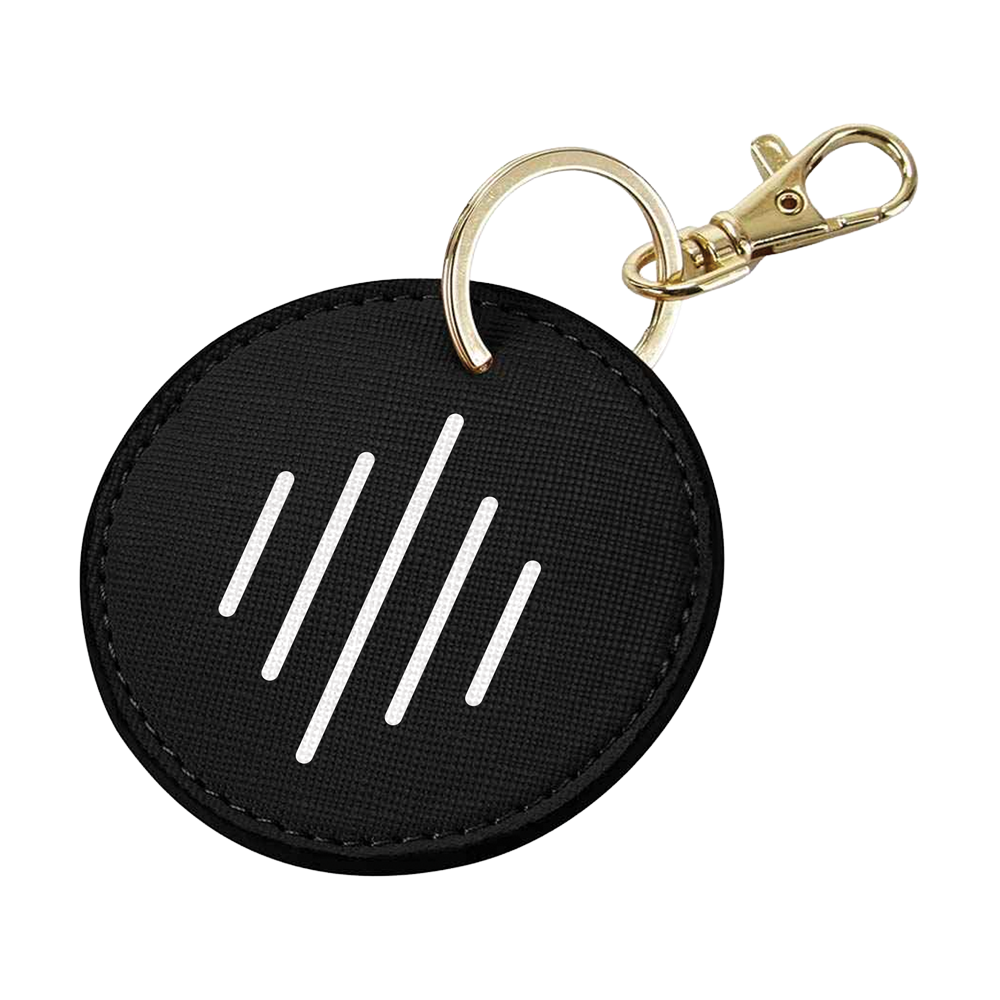 Black round keychain with white symbols and gold clasp on a white background